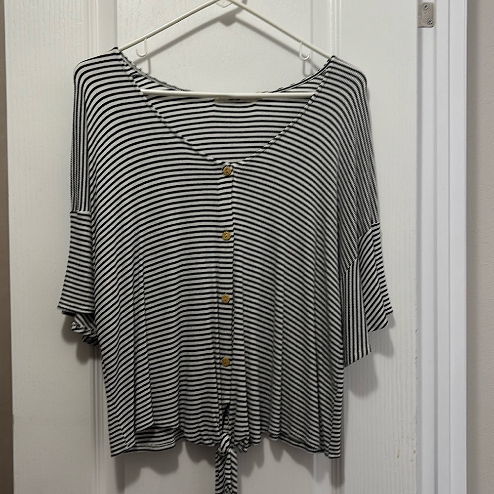 Black and white striped shirt, with tie in front.